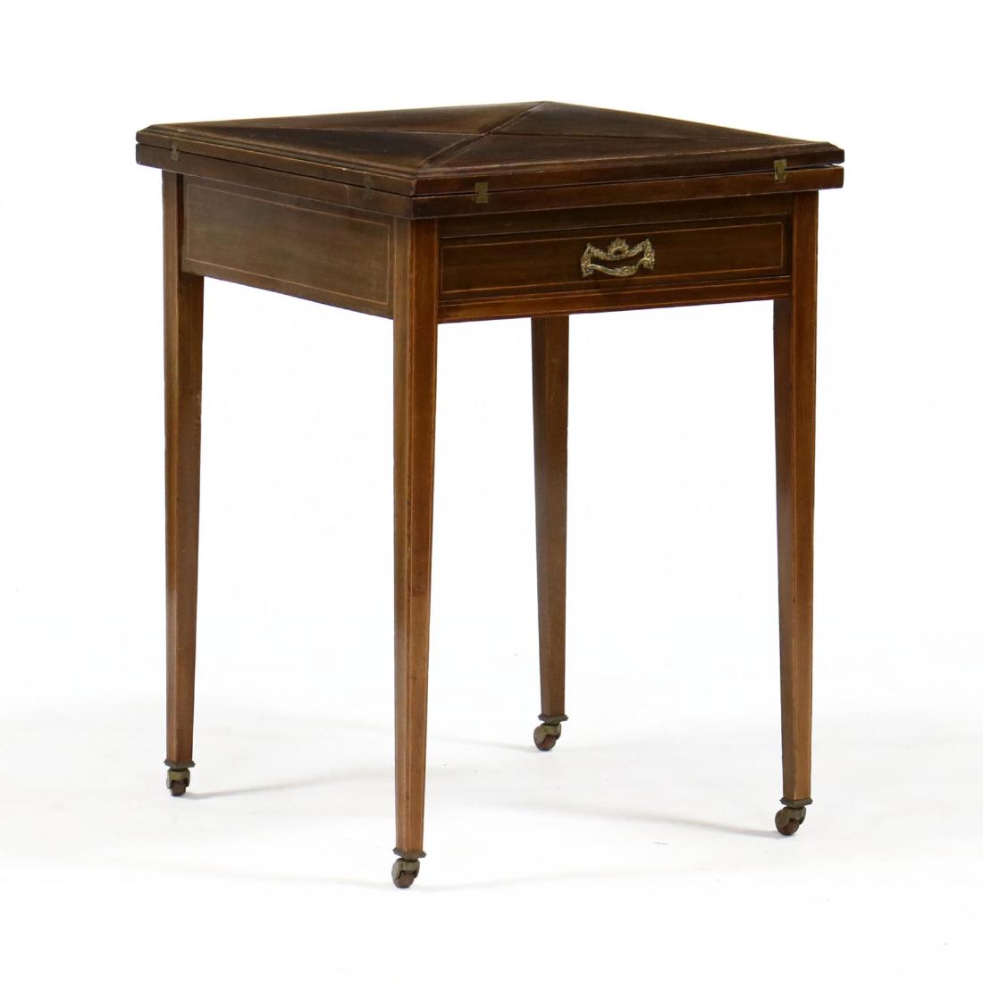 Edwardian Inlaid Mahogany Handkerchief Table: Edwardian Inlaid Mahogany Handkerchief Table circa 1900, swivel square top, with molded edge and banded inlay, four hinged leaves, opening to reveal a felt playing surface with recessed wells, single 