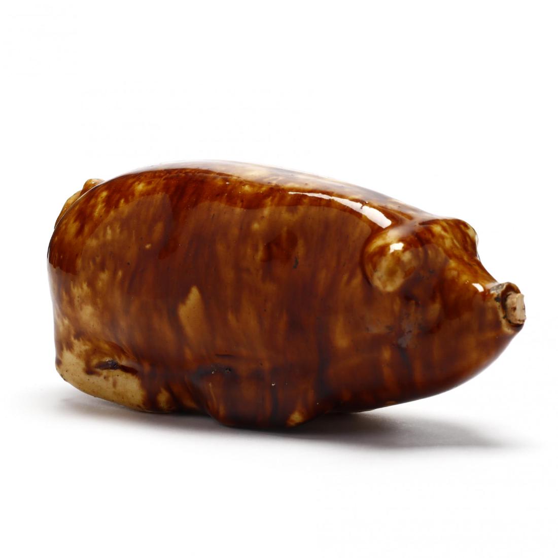 Bennington / Rockingham Pig Flask: Bennington / Rockingham Pig Flask20th century, modeled after the Anna Pottery flasks of the 19th century, snout with small aperture and cork. 3 x 6.25 in. Family history states that in the mid to late
