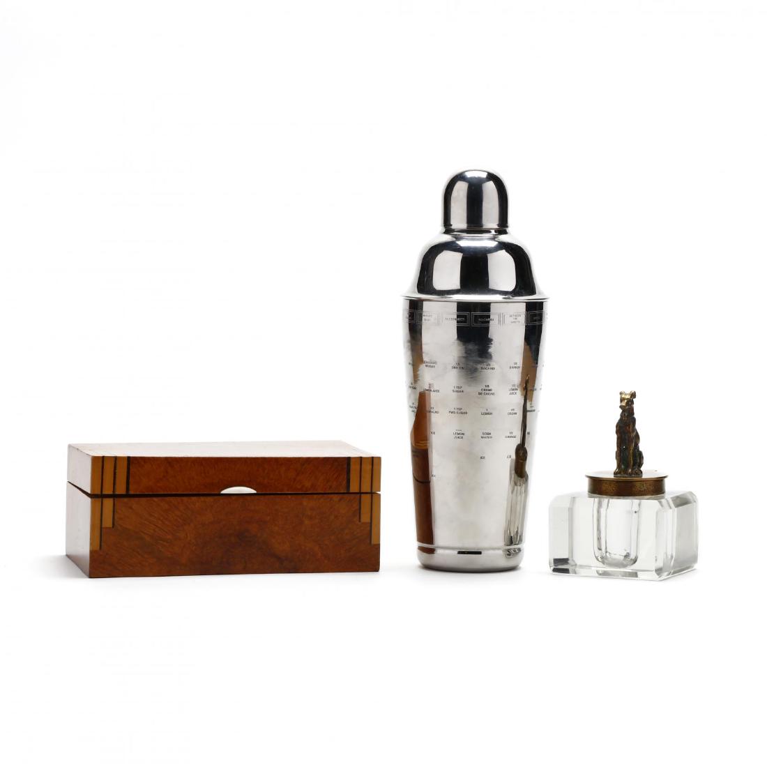 Art Deco Desk Accessory Grouping: Art Deco Desk Accessory Groupingincluding an early 20th century brass and cut glass ink well in the form of a hound; a 1930s inlaid burlwood box with lip handle; and a contemporary steel cocktail shak