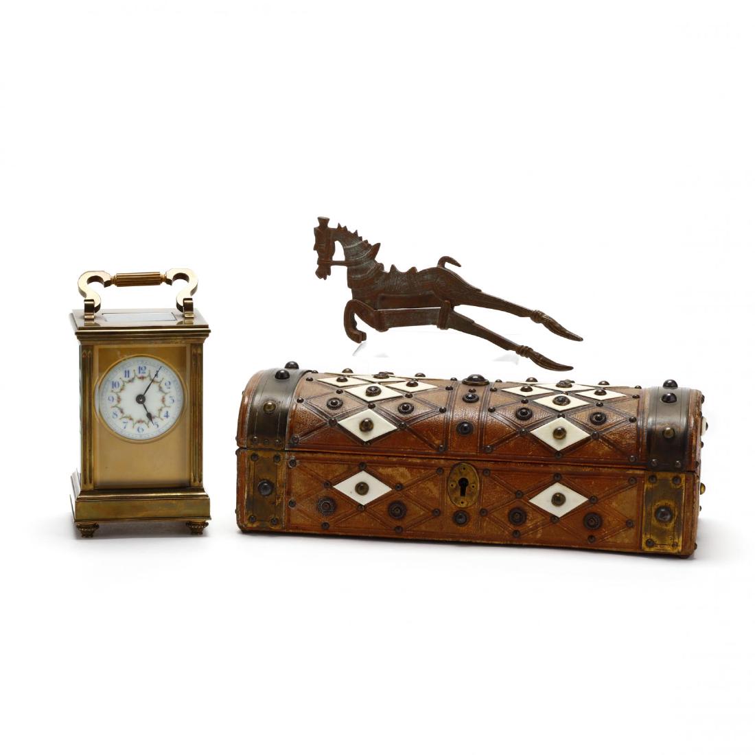 Three Antique Desk Accessories: Three Antique Desk Accessories 19th century, including a domed box with tooled leather and mounts; French brass and glass carriage clock with painted porcelain face; and an Egyptian style patinated me