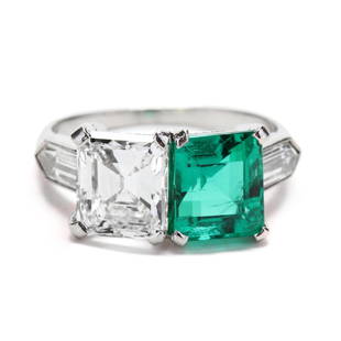 Platinum, Diamond, and Colombian Emerald Ring: Platinum, Diamond, and Colombian Emerald Ring the two stone ring with one prong set emerald cut diamond weighing 1.81 carats (actual) (E color, VS1 clarity) and one prong set emerald cut Colombian