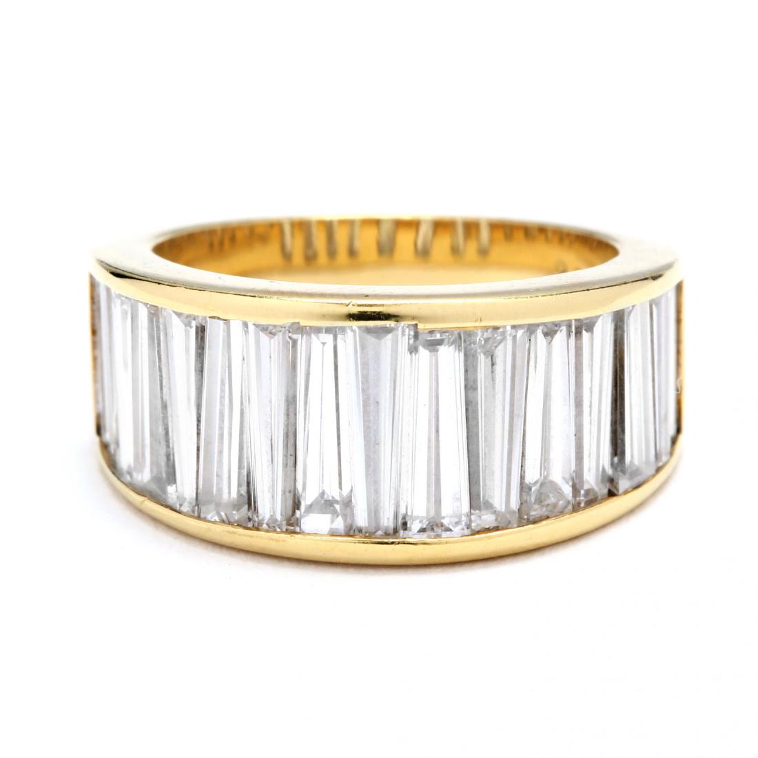 18KT Gold and Diamond Ring, signed: 18KT Gold and Diamond Ring, signedin a tapered band design with channel set baguette cut diamonds weighing approximately 5.03 total carats (F-G color, VS clarity), stamped 2 0 8 5 6 and with a maker's