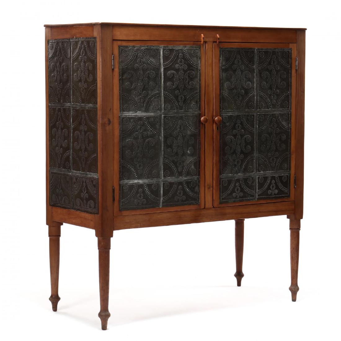 Southern Punched Tin Pie Safe: Southern Punched Tin Pie SafeVirginia, attributed to Campbell County, mid-19th century, poplar and white pine, (24) punched tins with repeating lunette and scrolled design, two large hinged doors, she