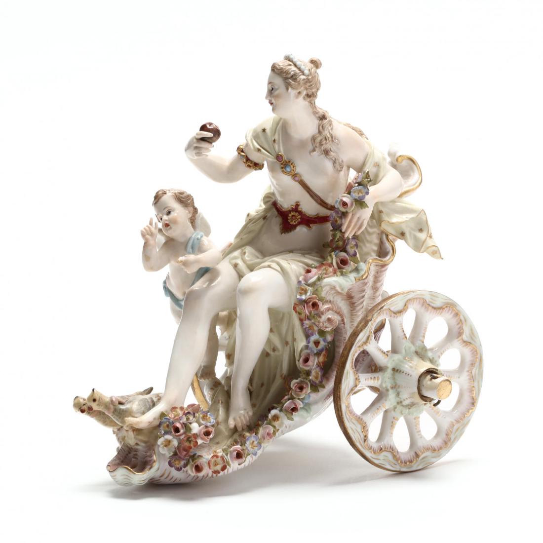 A Meissen Porcelain Chariot Group of Venus and Cupid: A Meissen Porcelain Chariot Group of Venus and Cupid late 19th or early 20th century, the goddess is modeled holding the apple of discord as well as a trailing garland of flowers, seated on an open sh
