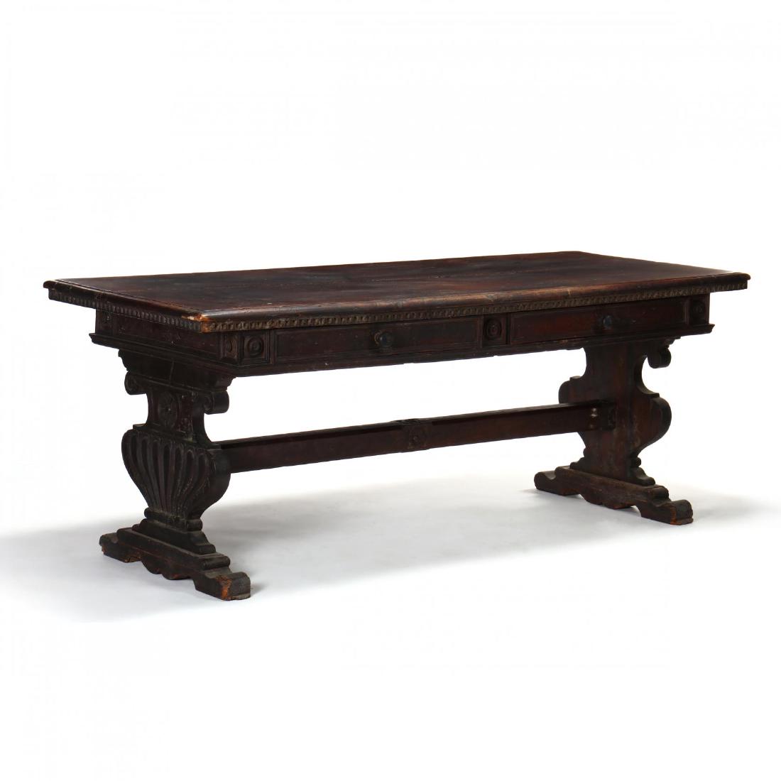 Italian Renaissance Carved Walnut Library Table: Italian Renaissance Carved Walnut Library Table 17th century, rectangular two-board molded top, one side with two side-by-side applied molded drawers, flanked by applied rondels, the top with shaped a