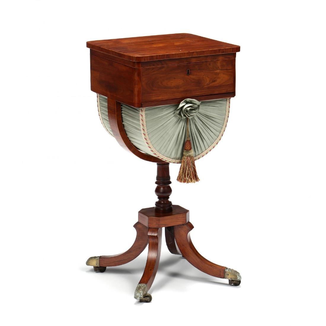 Regency Rosewood Sewing Stand: Regency Rosewood Sewing Stand early 19th century, rosewood veneer, pine secondary, rectangular hinged lidded compartment with a divided interior, above a pull-out silk lined sewing basket, turned stan