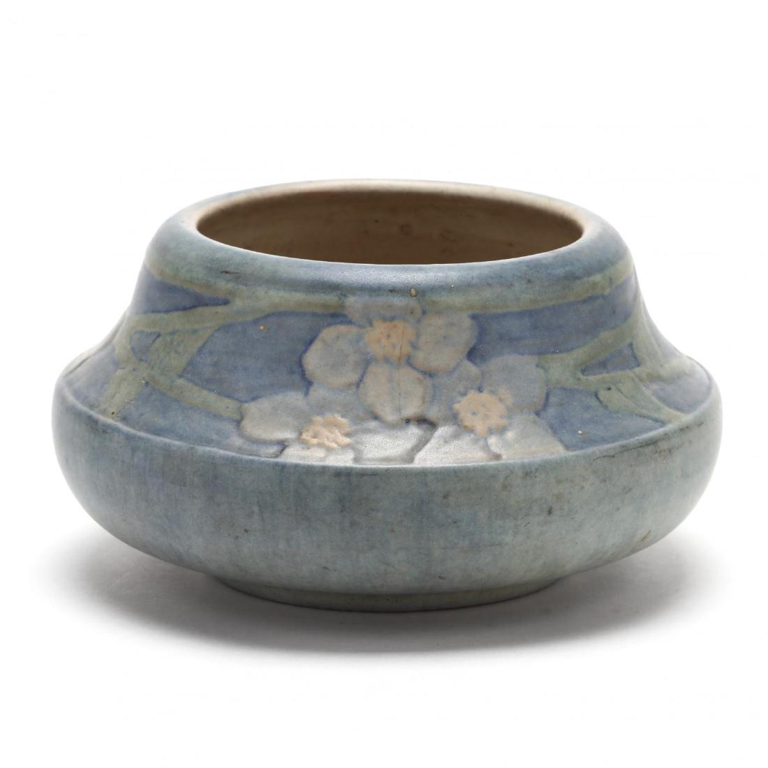 Newcomb College Art Pottery Low Bowl: Newcomb College Art Pottery Low Bowl date cipher for 1913, decorator inscribed initials "A.M," matte glaze, angular form with low ring foot, relief carved with a band of dogwood blossoms. 3 x 5 in. Es