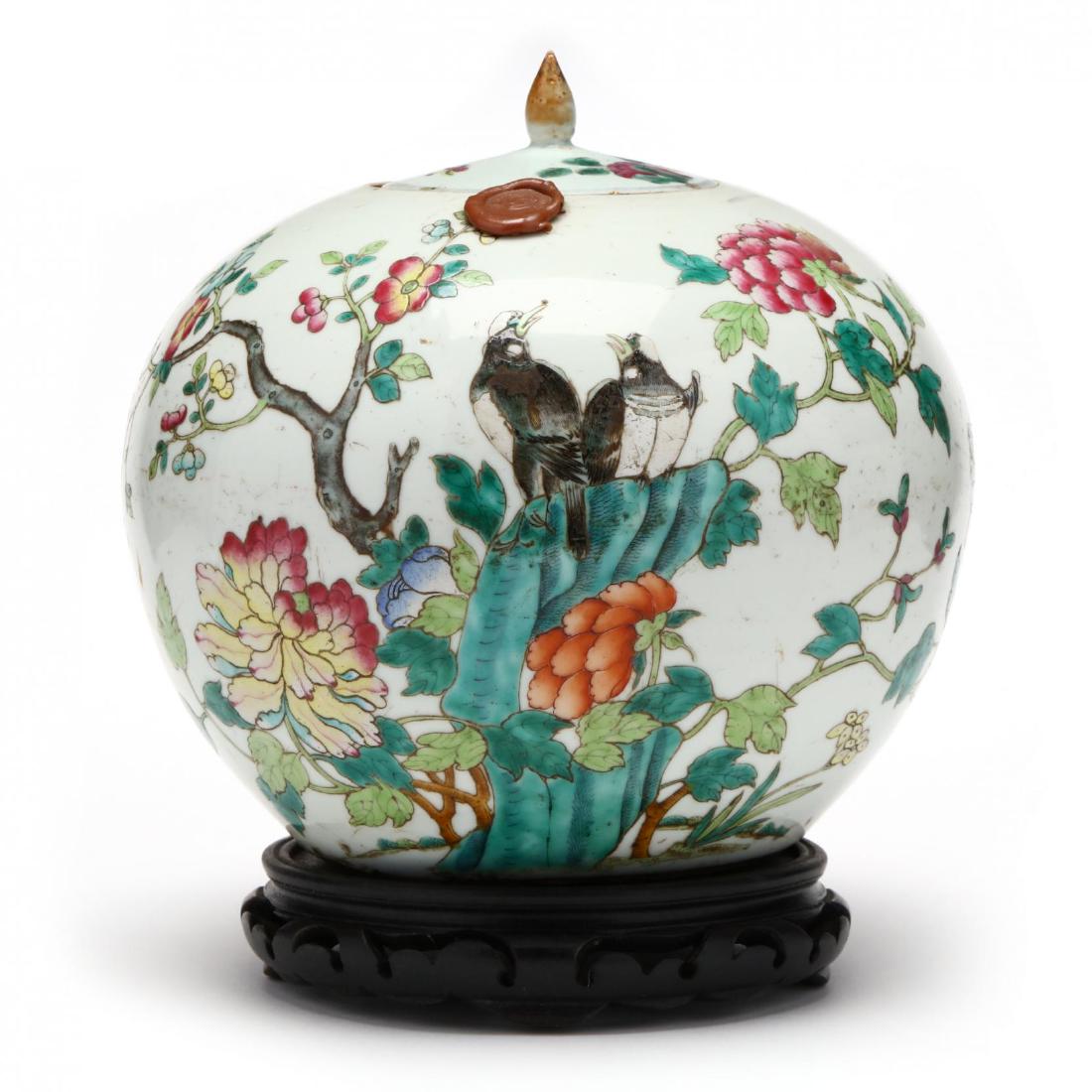 A Chinese Export Porcelain Lidded Ginger Jar: A Chinese Export Porcelain Lidded Ginger Jar19th century, a four character mark in red to underside, decorated in bright enamels with flowering branches and a pair of birds perched on a rock, lid deco