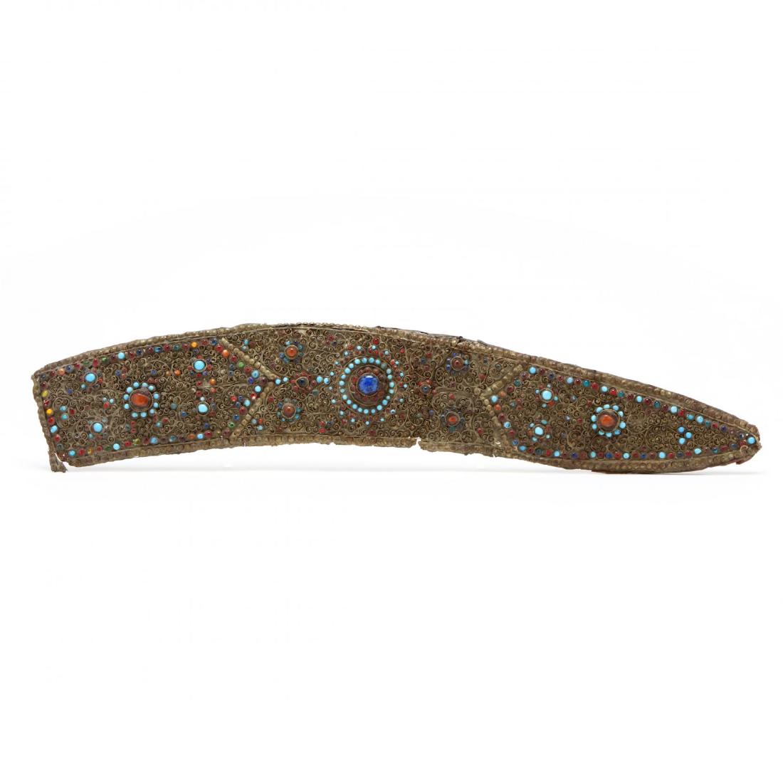 A Nepalese Kukri Scabbard: A Nepalese Kukri Scabbard probably 18th or 19th century, inlaid with round stones some turquoise, raised metal spirals, metal beading around edges. 22.5 in. Private Collection, North Carolina Addition