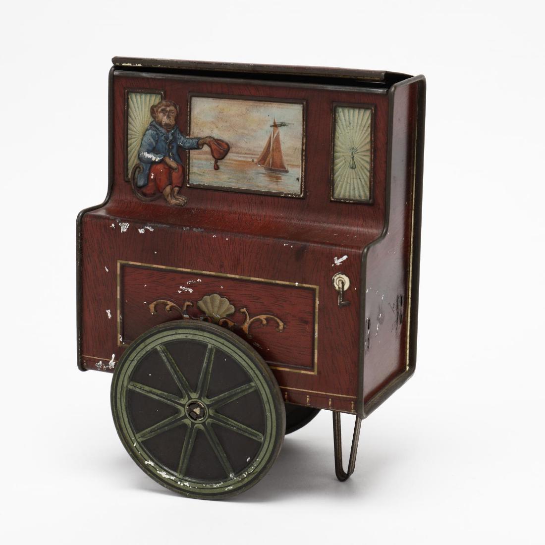 William Crawford Organ Grinder Biscuit Tin: William Crawford Organ Grinder Biscuit Tinmade in England, circa 1910, red wagon body with small monkey holding out a cap for tips, turning disc wheels, hinged top opens. 6.25 x 4.75 in. Private Colle