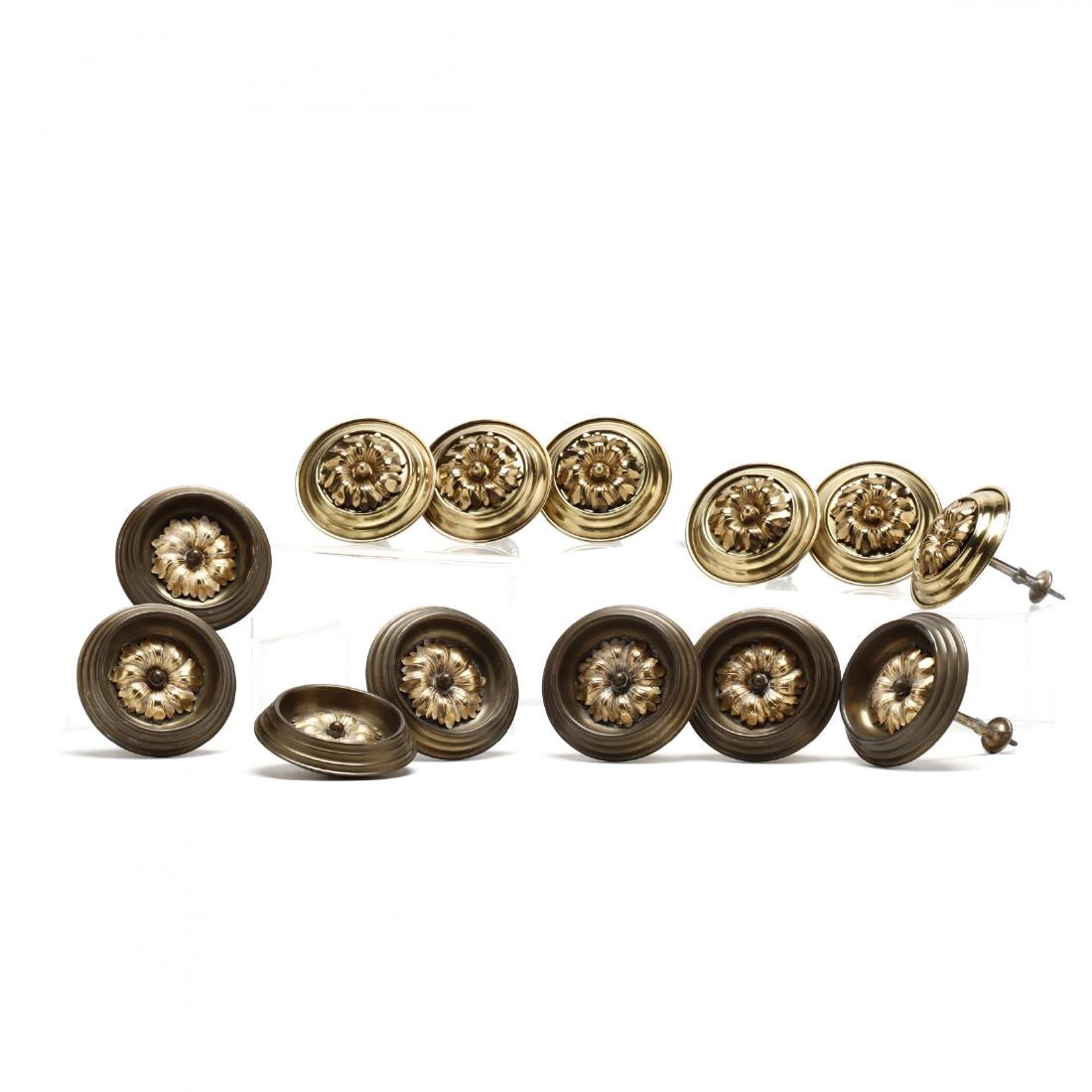 Group of (13) Brass Curtain Tie Backs: Group of (13) Brass Curtain Tie Backs early 20th century, in two sets, each with rosette to center of rondel. Each approx 3.75 in diameter. From the Collection of the Saunders Family; the Historic Lea