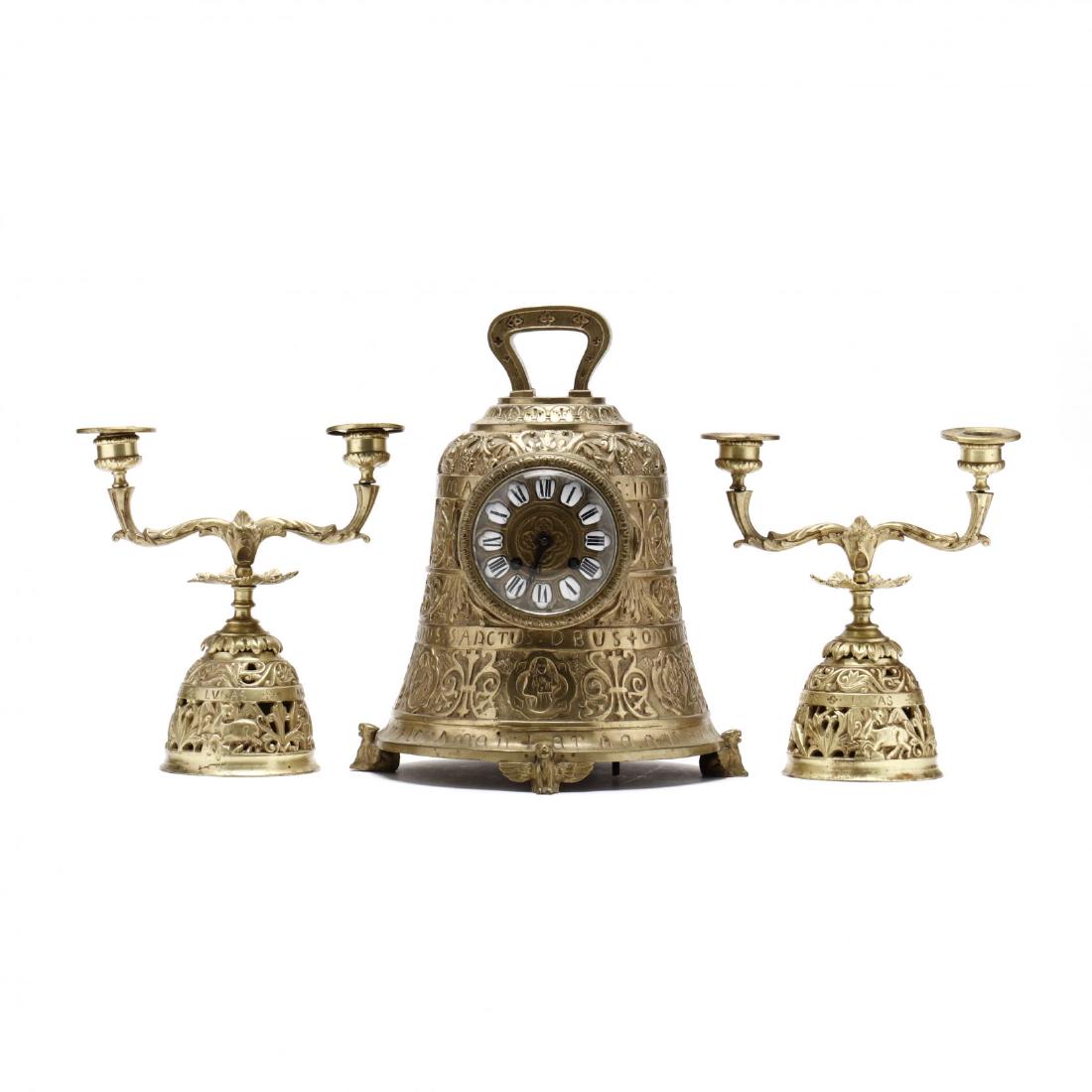French Bell-Form Pater Noster Ormolu Clock Garniture: French Bell-Form Pater Noster Ormolu Clock Garniture circa 1900, the brass time and strike movement marked JAPY FRERES & CIE, the case is cast with lines of incuse Latin verse between high relief medi