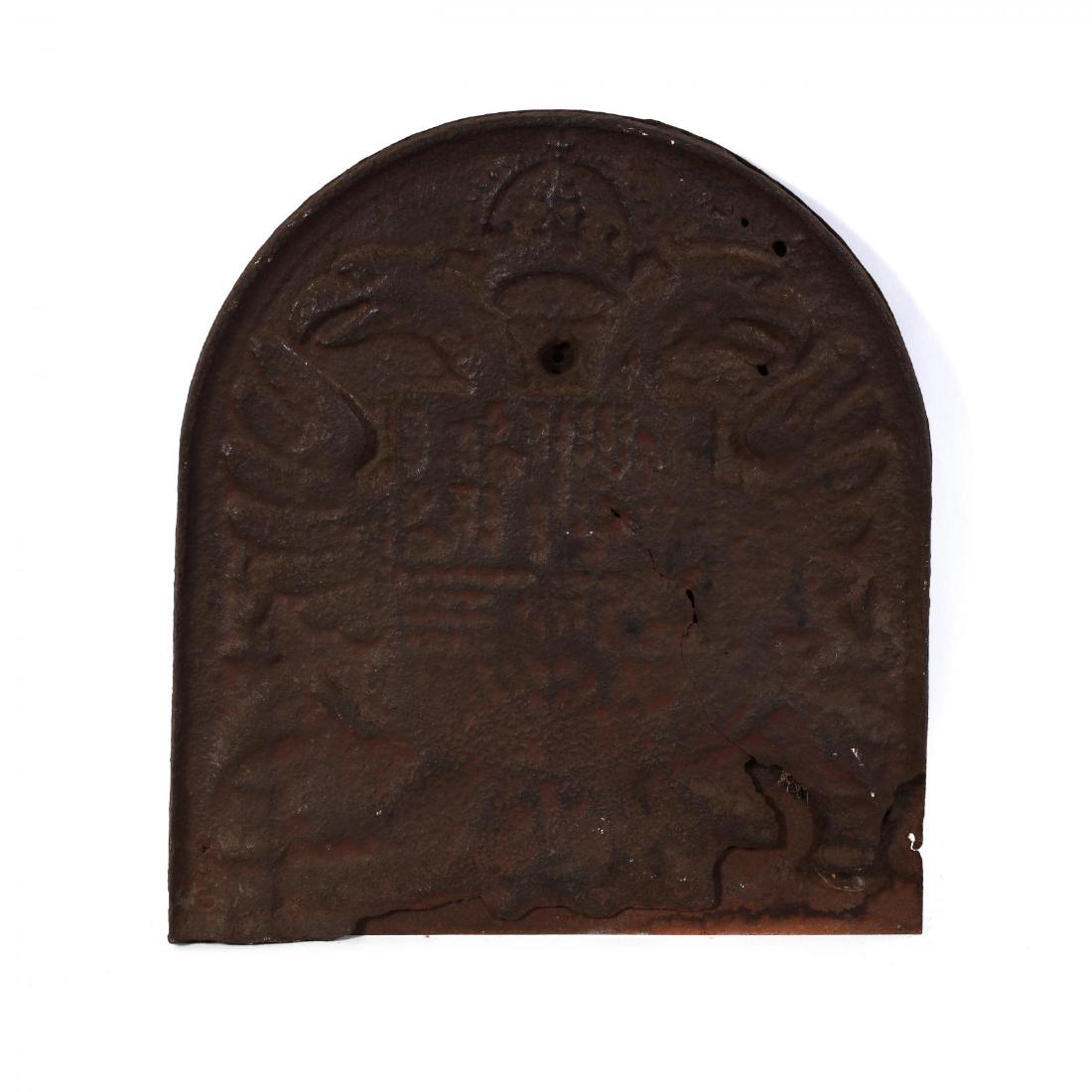 Early Antique Heraldic Iron Fireback: Early Antique Heraldic Iron Firebacklikely European, 18th century, featuring a shield with double headed eagle and crown, welded to later iron support. 21 x 18.5 in. Additional high-resolution photos