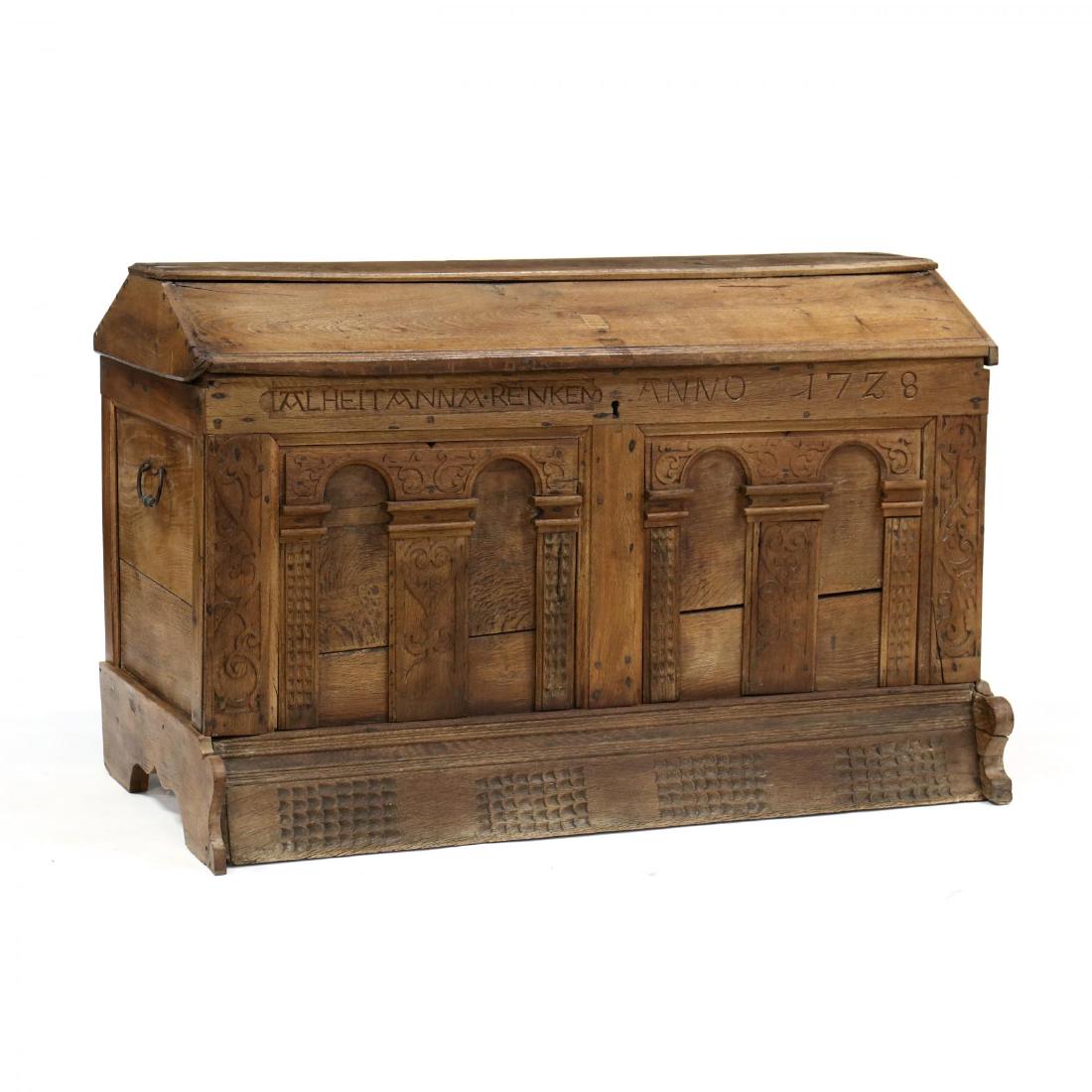 An Antique Continental Carved Oak Dowry Chest: An Antique Continental Carved Oak Dowry Chest 18th century, raised panel hinged lid, interior with till, iron bail handles to sides, front panel with relief carving and inscription reading "Ualheitann