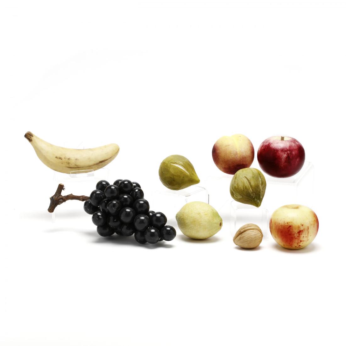 Nine Pieces of Carved Stone Fruit: Nine Pieces of Carved Stone Fruit second half 20th century, including a banana, grapes, apple, figs, lemon, peach and walnut. Longest 9 in. From the Estate of the late Judy Blondeau, Raleigh, NC Addit