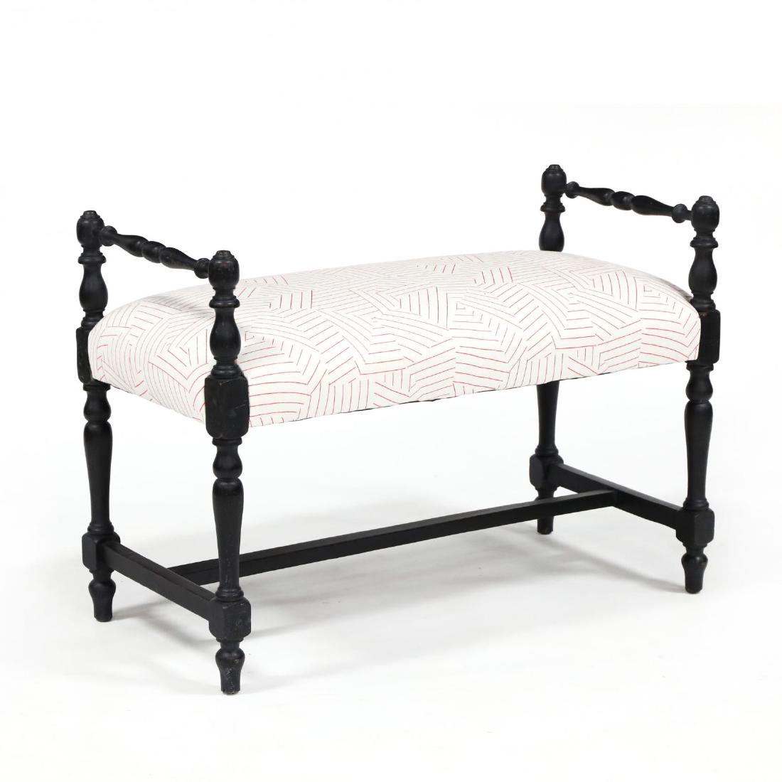 Colonial Style Painted Bench: Colonial Style Painted Bench early 20th century, carved and distressed painted surface in black with contemporary white and red printed upholstery. 25 x 35 x 17 in. Additional high-resolution photos a