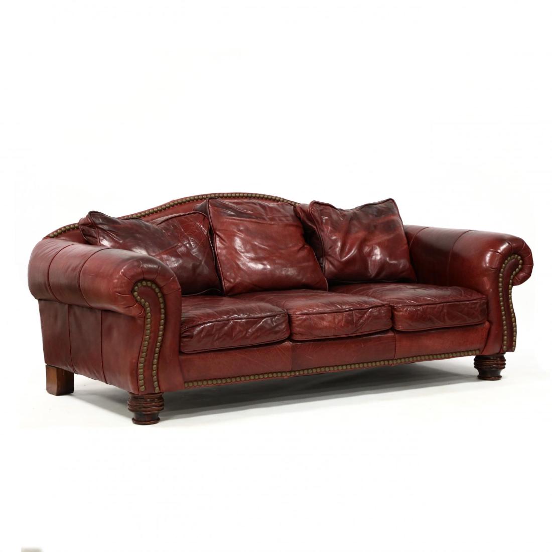 Century Furniture, Leather Upholstered Sofa: Century Furniture, Leather Upholstered Sofa late 20th century, burgundy leather with brass nailhead trim, camelback frame, with loose cushions, raised on turned legs, labeled. 36 x 88 x 38 in. From th
