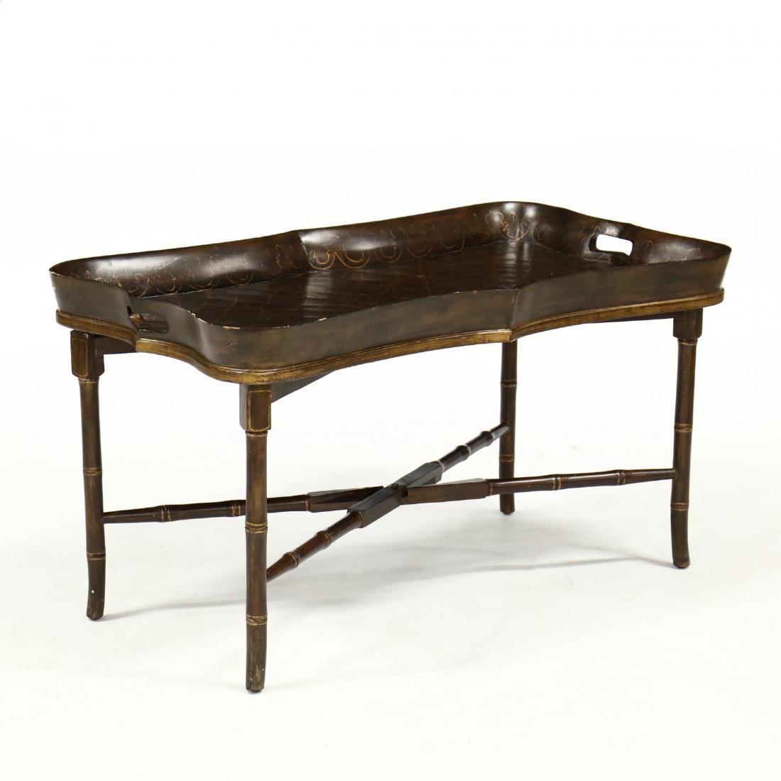 Contemporary Chinoiserie Tray Top Coffee Table: Contemporary Chinoiserie Tray Top Coffee Table two-part form, wood and composition, shaped rectangular tray with gilt chinoiserie decoration with antiqued craquelure finish, on folding faux bamboo str