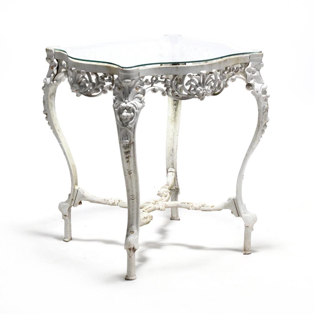 Victorian Style Glass Top Garden Table: Victorian Style Glass Top Garden Table early 20th century, later white paint, Rococo style reticulated frame, with shell and fruit decoration, stretcher base, raised straight feet. 30 x 23.5 x 23.5 in