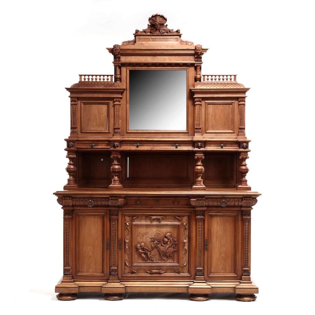 Italian Baroque Style Carved Walnut Sideboard: Italian Baroque Style Carved Walnut Sideboard late 19th century, three-part form, pronounced pediment featuring carved busts, fluted columns, turned spindles, and fish-scale panels, with central bevel