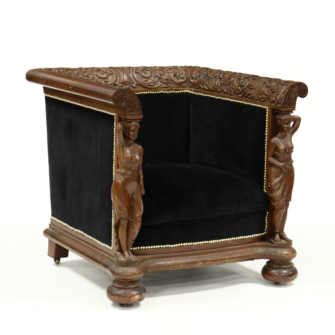 Renaissance Revival Carved Mahogany Library Chair: Renaissance Revival Carved Mahogany Library Chair circa 1890, acanthus scrolled relief carved crest and arms, supported by fully carved Classical figures, with later black velvet upholstery and brass 