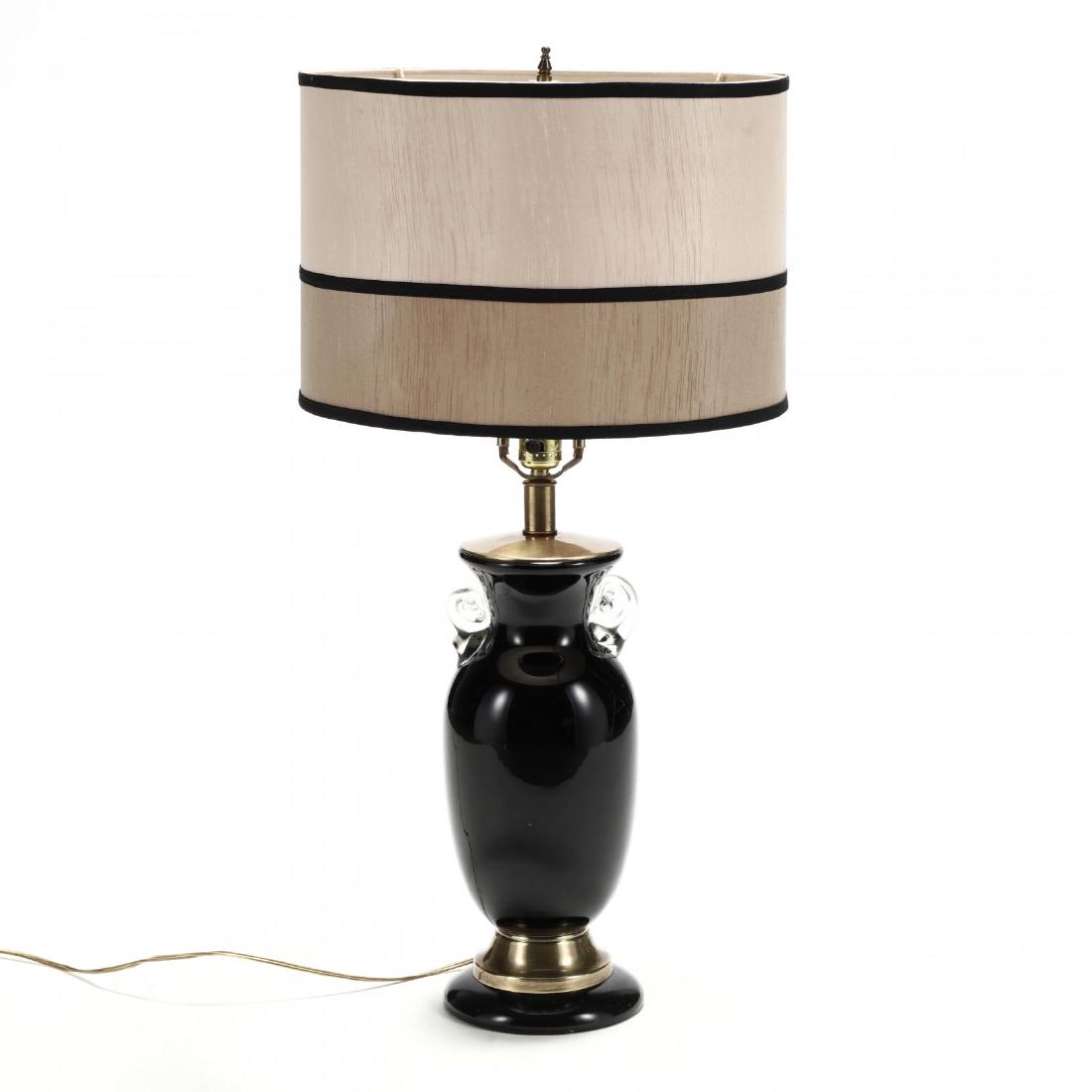 Frederick Cooper, Murano Glass Table Lamp: Frederick Cooper, Murano Glass Table Lamplate 20th century, blown black glass with applied clear handles, brass mounts, with two tone taupe drum shade, labeled. HOA 30 in. Additional high-resolution