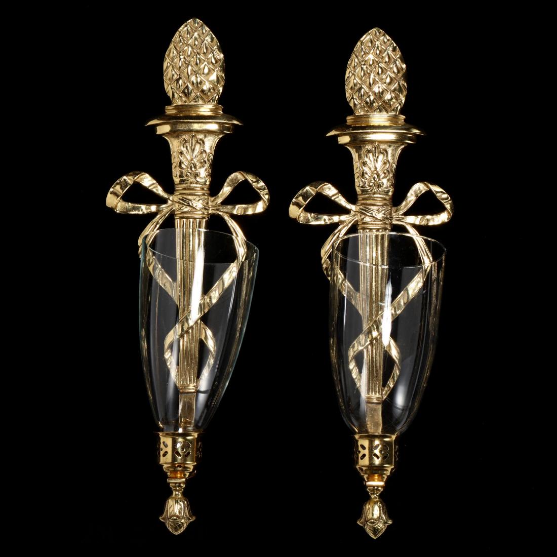 Virginia Metalcrafters, Pair of Brass Wall Sconces: Virginia Metalcrafters, Pair of Brass Wall Sconces late 20th century, cast brass wall mounts with artichoke and ribbon, glass hurricanes, marked. 21 in. tall. Additional high-resolution photos are ava