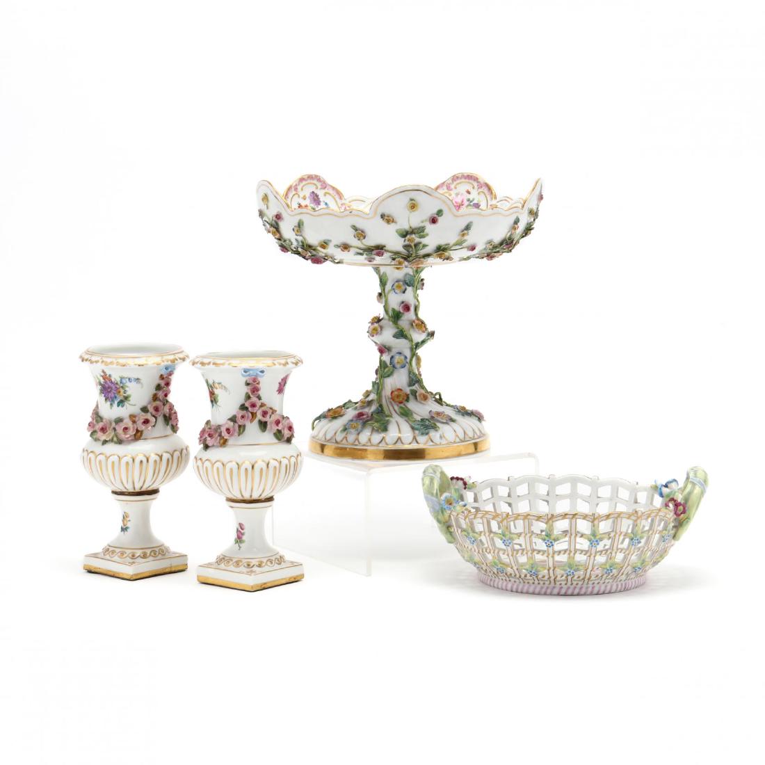 An Antique Porcelain Grouping: An Antique Porcelain Groupingto include: a KPM reticulated basket, with scepter and orb back stamp (3.5 x 8.25 in.); a pair of Dresden vases, two part urn form festooned with applied garlands (7 in.);