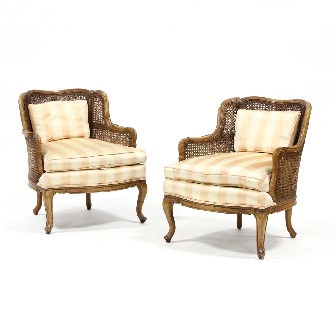 Jamestown Lounge Co., Pair of Louis XV Style Bergere: Jamestown Lounge Co., Pair of Louis XV Style Bergere circa 1970, carved walnut frames with double cane backs, striped silk upholstery with loose cushions, labeled. 30 x 26 x 33 in. Collection of Clyde