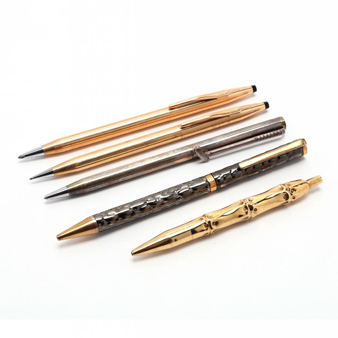 An Assortment of Writing Instruments: An Assortment of Writing Instrumentsa Mark Cross gold plated pen and pencil; a Gucci ballpoint pen; a Tiffany sterling golf motif ballpoint with bag and box: an unmarked ballpoint in the shape of a ba