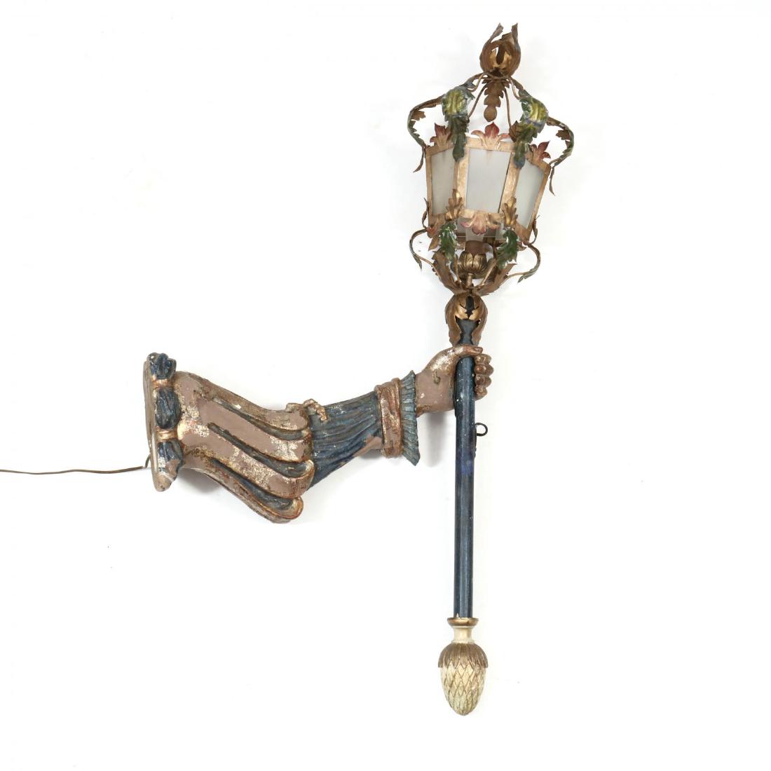Antique Carved and Painted Torchiere: Antique Carved and Painted Torchiere early 20th century, carved and painted wood arm holding a wood and metal electrified torchiere, with label appearing to read "Maria De Guardia, New York, Made in I