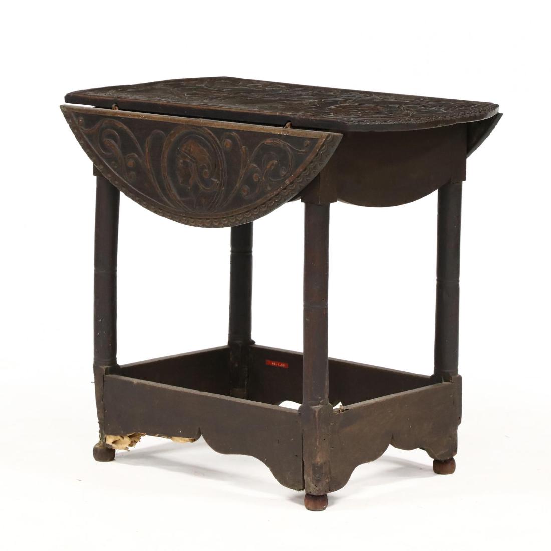 Antique Spanish Relief Carved Allegorical Drop Leaf: Antique Spanish Relief Carved Allegorical Drop Leaf Tablethe top, early 18th century or 17th century, comprised of four boards, each drop leaf with a central bust of male and female respectively, with