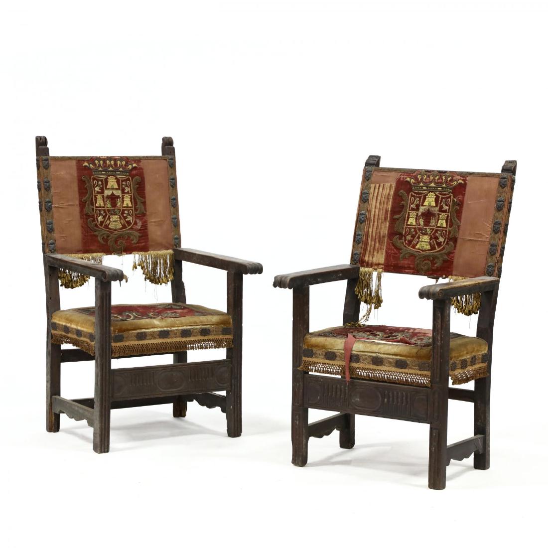 Pair of Similar Italian Baroque Carved Armchairs with: Pair of Similar Italian Baroque Carved Armchairs with Coat-of-Arms Appliques late 17th century, the two chairs likely a his and hers pair, both with stylized relief carved finials, carved and scrolled