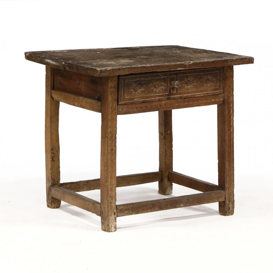Spanish Colonial Carved Walnut One Drawer Table: Spanish Colonial Carved Walnut One Drawer Table18th century, one board rectangular top, relief carved drawer featuring rosettes, chip carved legs, on box stretcher base. 30 x 34 x 25 in. From the Coll