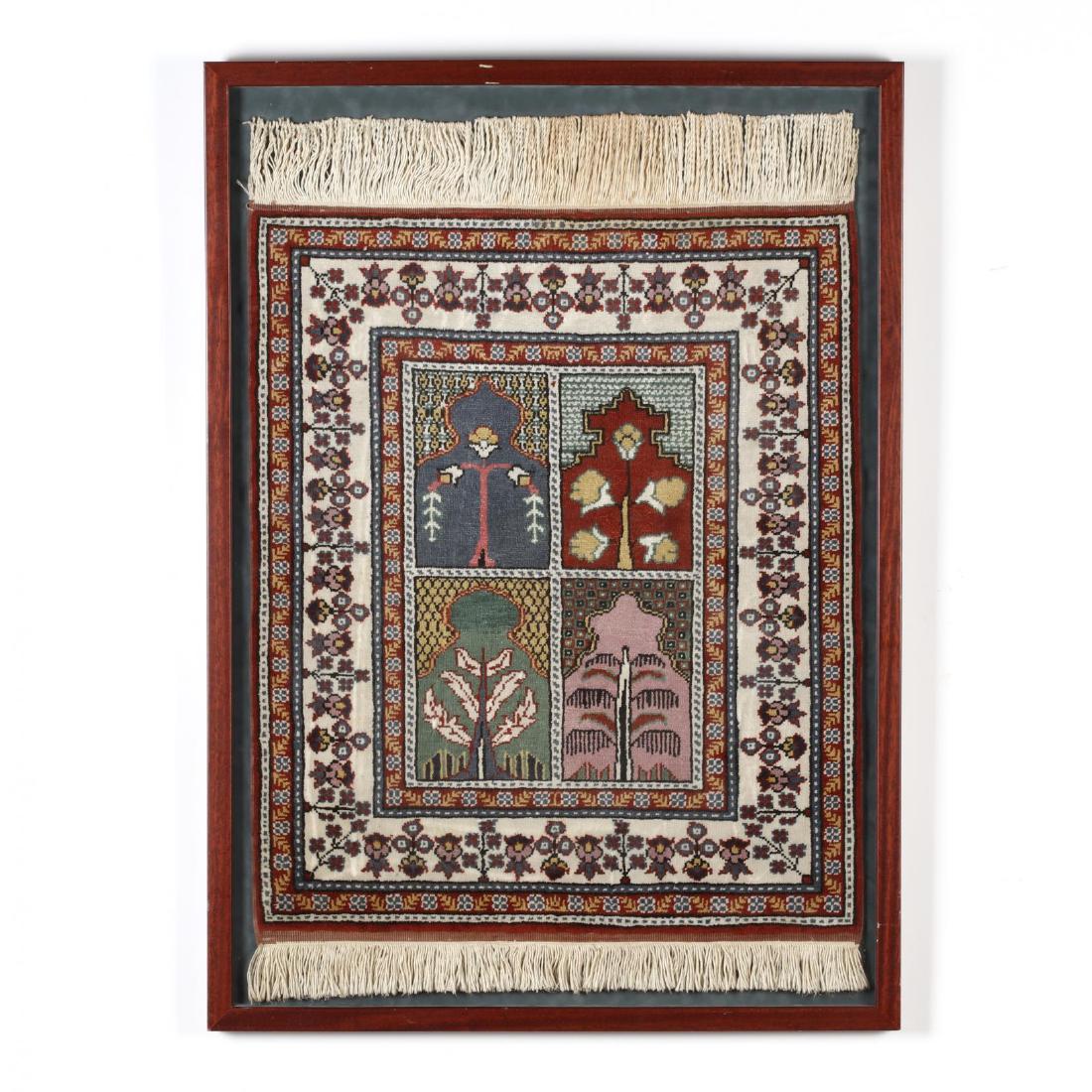 Framed Turkish Rug: Framed Turkish Rug the field with a center panel comprised of four quadrants, each in a prayer rug motif with a stylized tree design, nicely presented in a contemporary frame. DOA 38 x 27.5 Private Co