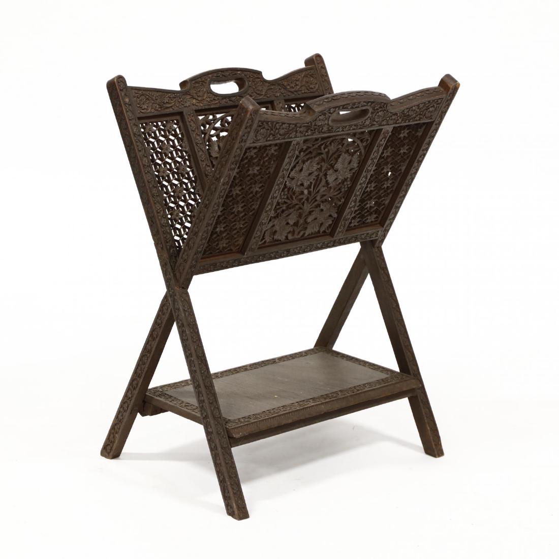 Antique Burmese Carved Teak Magazine Rack: Antique Burmese Carved Teak Magazine Rack early 20th century, with all over foliate and geometric carving featuring reticulated panels, lower shelf on splayed legs. 27 x 19 x 15 in. From the Collectio