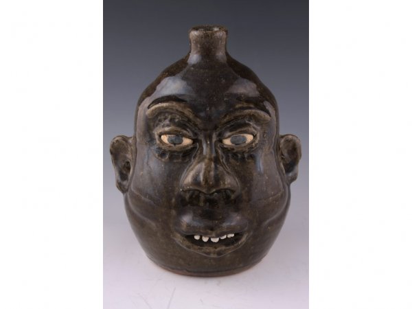 GA Folk Pottery Face Jug, Lanier Meaders,: GA Folk Pottery Face Jug, Lanier Meaders, 1980s, all over alkaline glaze, clay teeth, unglazed eyes, with flared nose and protruding lips, signed in script on bottom "Lanier Meaders" - 10"