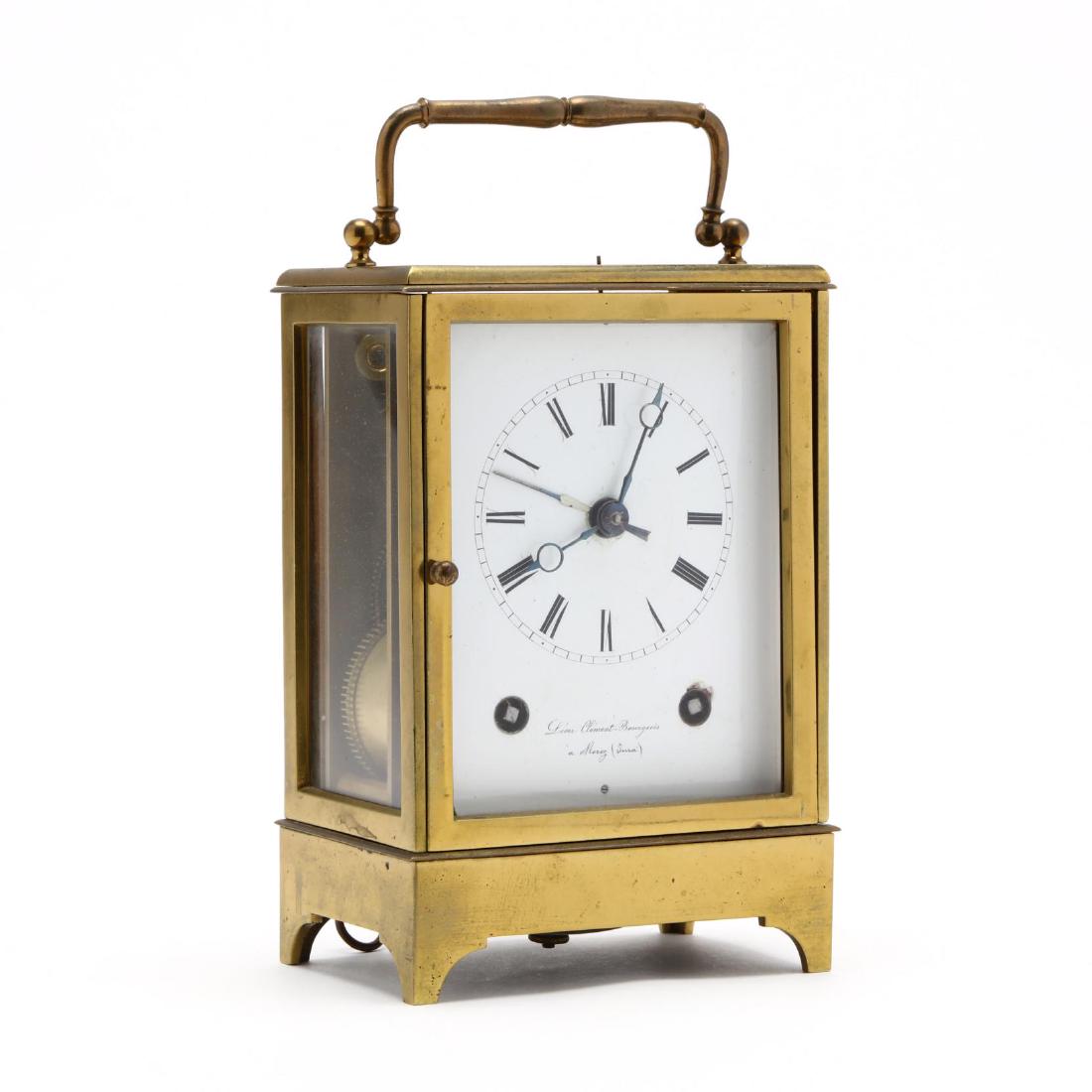 French Brass Carriage Alarm Clock: French Brass Carriage Alarm Clock circa 1900, enamel face signed "Leon Clement Bourgeois a Morez (Terra)", with alarm pull mechanism, carrying handle to top. 9 x 5 x 3.5 in. Additional high-resolution