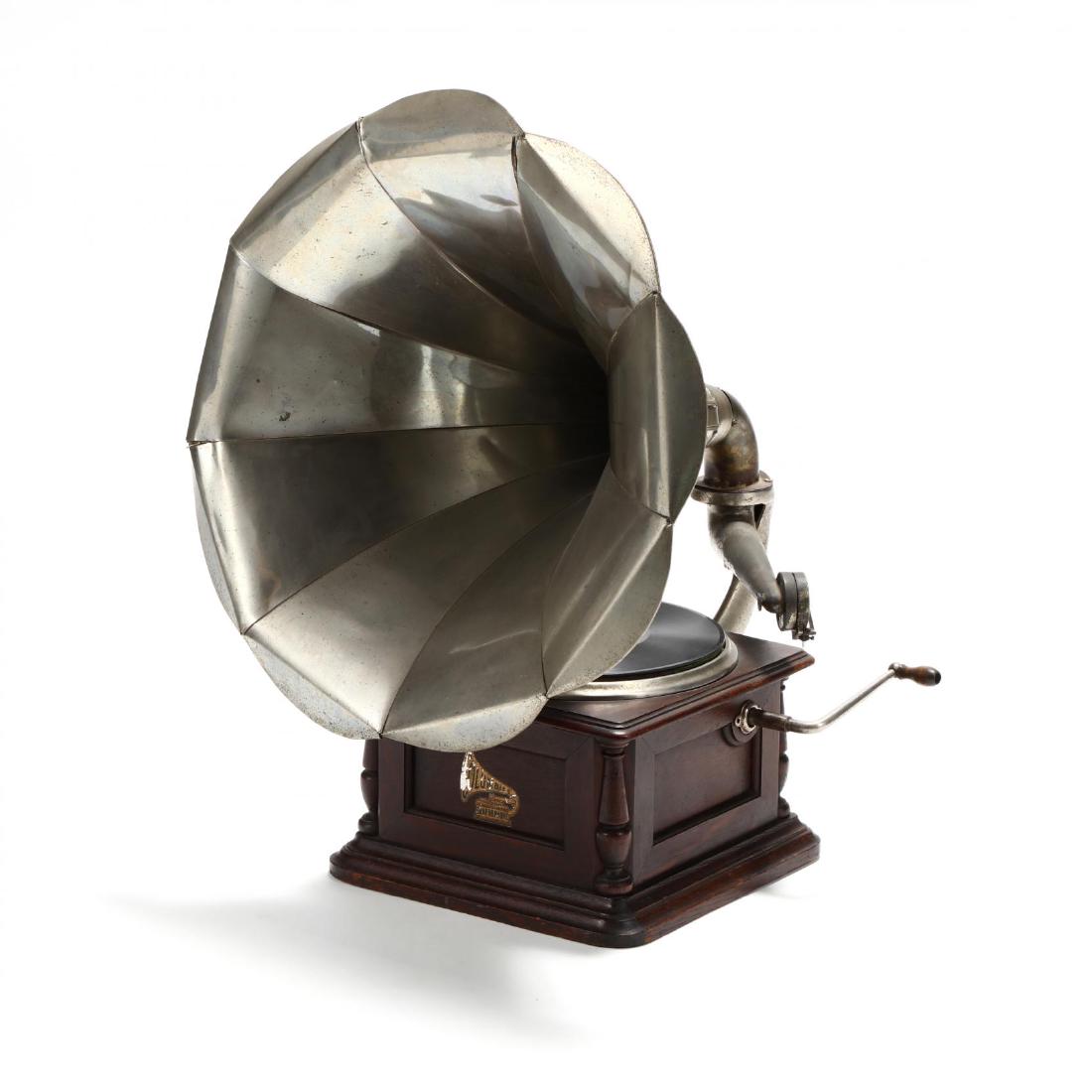 Columbia "Sterling" Disc Graphophone: Columbia "Sterling" Disc Graphophone circa 1910, nickel-plated brass bell flower horn, the oak cabinet with original decals having patent dates through 1906. From the Collection of Mary Wells, Greensb