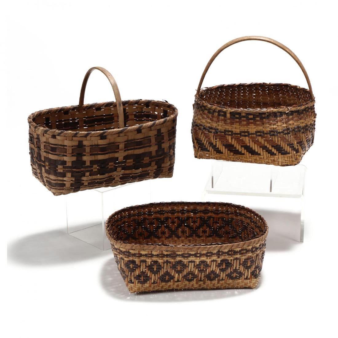 Three Cherokee Baskets: Three Cherokee Baskets20th century, two constructed of river cane, the third of oak splint all with dyed weavers. Rectangular Basket with handle 12.5 x 15 in. From the Collection of Mary Wells, Greens