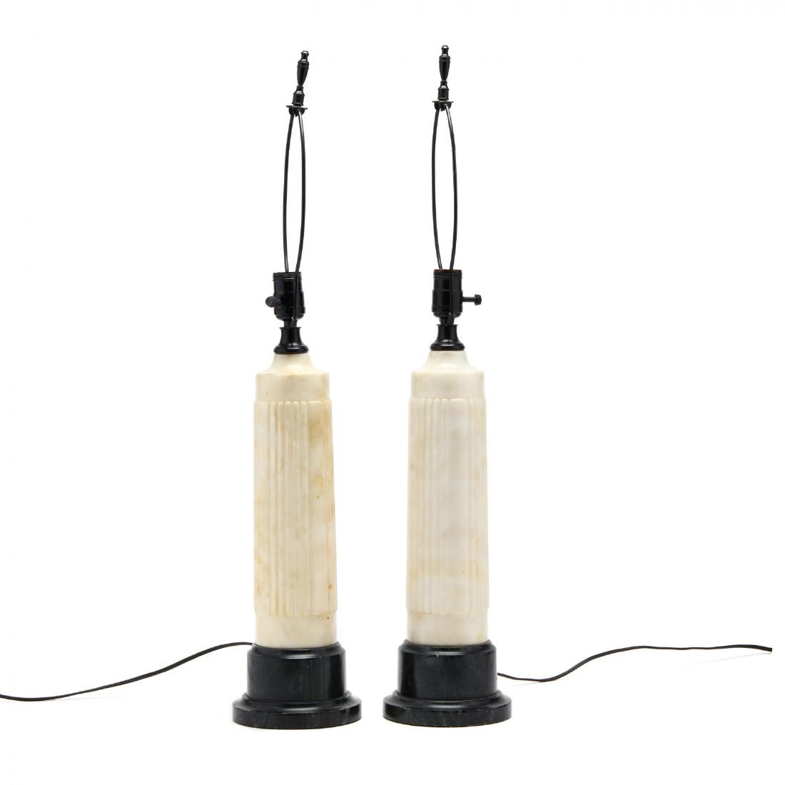 Pair of Art Deco Alabaster Table Lamps: Pair of Art Deco Alabaster Table Lamps early to mid 20th century, solid carved white alabaster columns with reeded design on a black stone plinth with black metal mounts. HOA 29 in. Additional high-re
