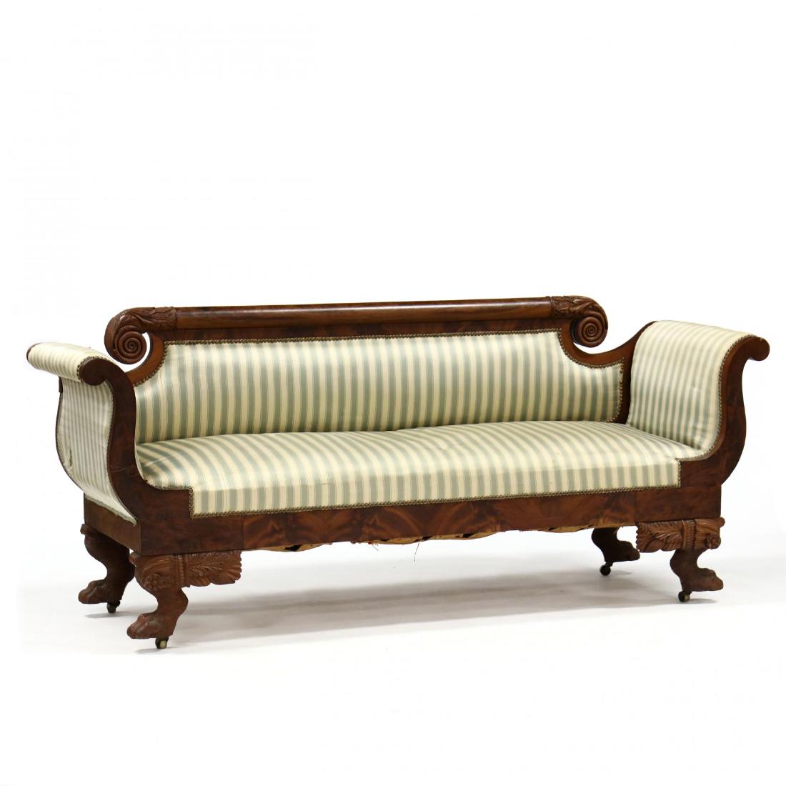 American Classical Carved Mahogany Sofa: American Classical Carved Mahogany Sofa Philadelphia or New York, circa 1840, carved mahogany with flame mahogany veneers, rounded crestrail terminating in acanthus leaf and bold scroll, with later st