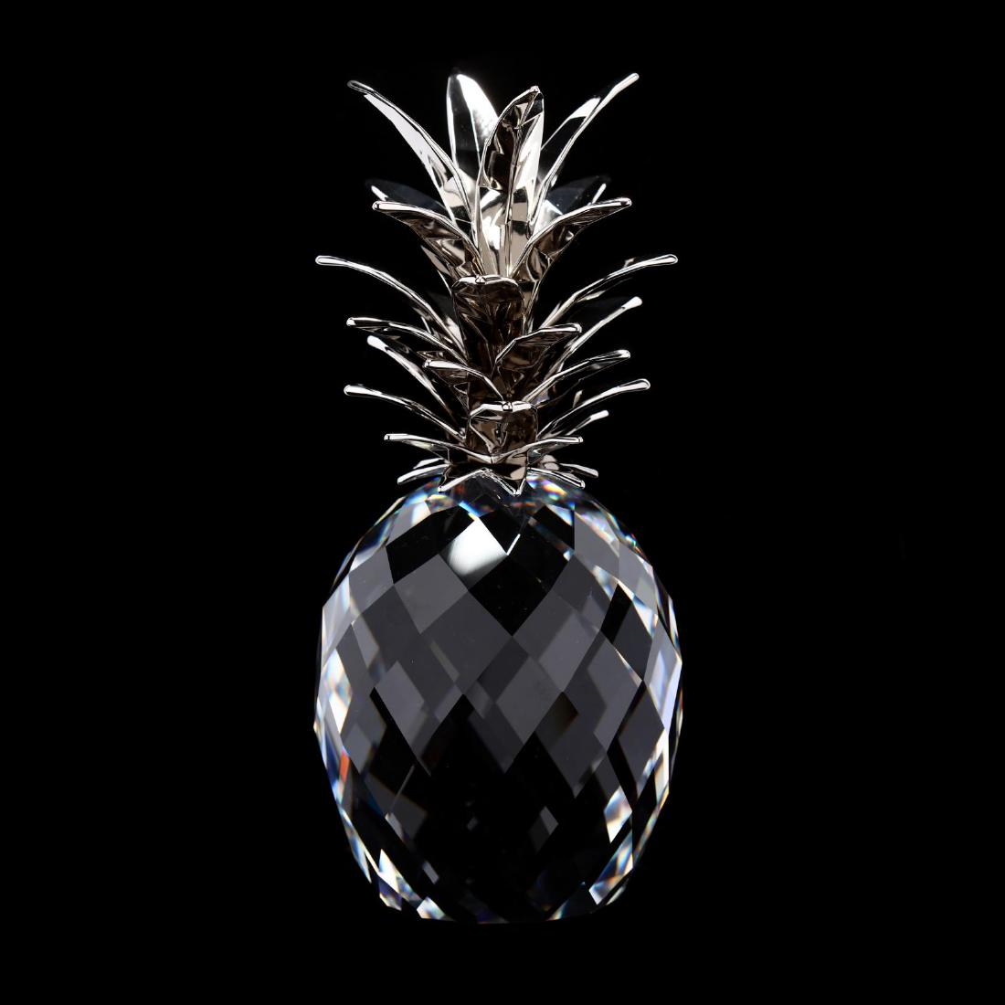 Swarovski, Large Pineapple: Swarovski, Large Pineapple item #5004641, chrome plated leaf mounts on a clear faceted crystal pineapple, marked, with box. 8 x 3.5 in. diameter. Collection of Stephen Coppala, Charlotte, North Caroli