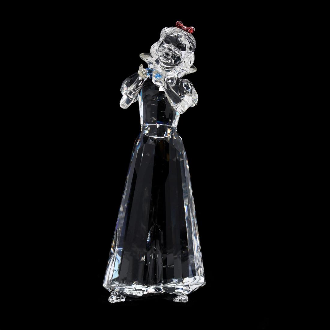 Swarovski, Disney Collection, Snow White: Swarovski, Disney Collection, Snow White item #994881, the clear faceted figure with pink bow and holding a blue stone, marked, with box. 5 in. Collection of Stephen Coppala, Charlotte, North Carolina