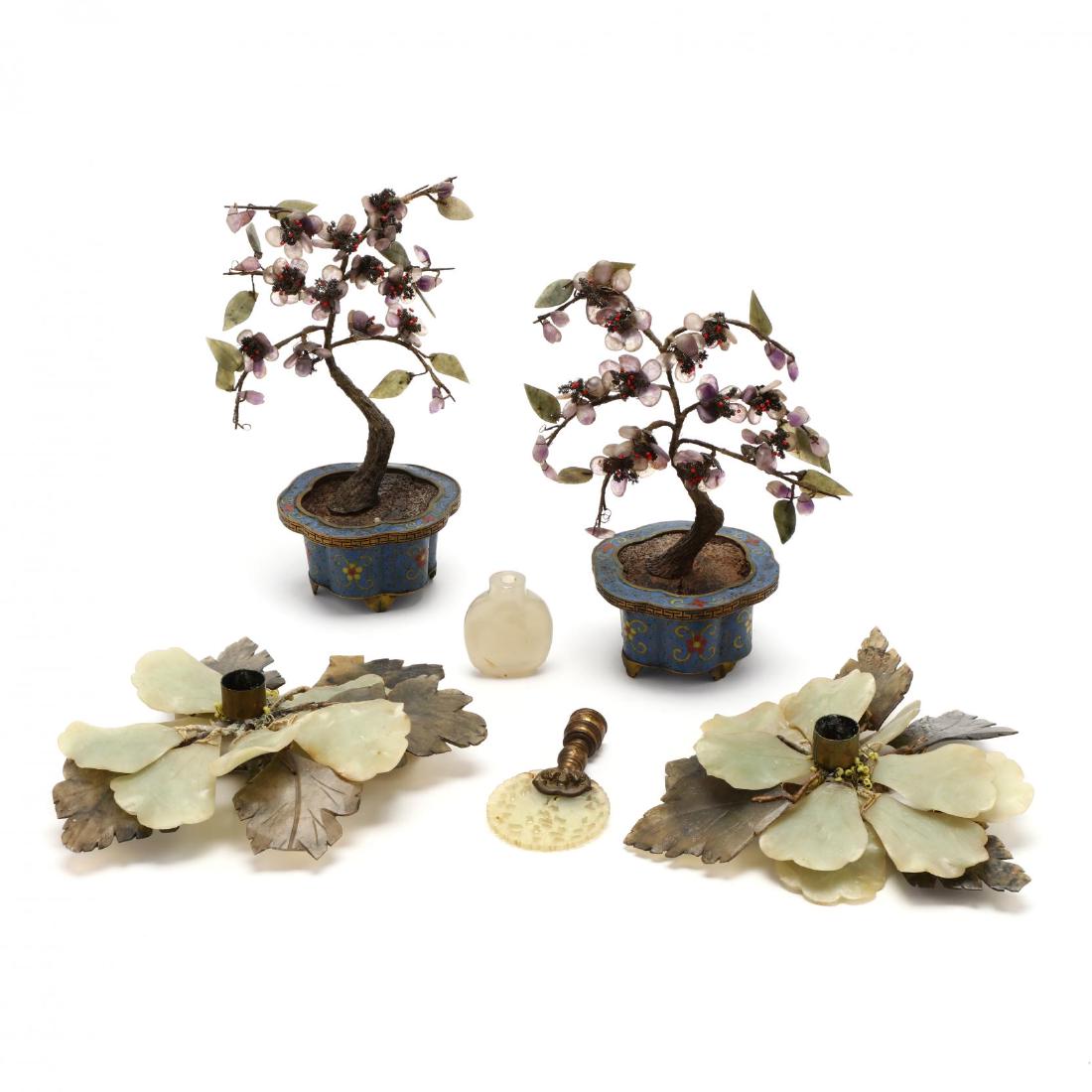 A Group of Chinese Hard Stone Decorative Items: A Group of Chinese Hard Stone Decorative Items includes a pair of purple hard stone trees in cloisonne pots, two candle holders with hard stone flower petals and leaves, a light celadon hard stone snu
