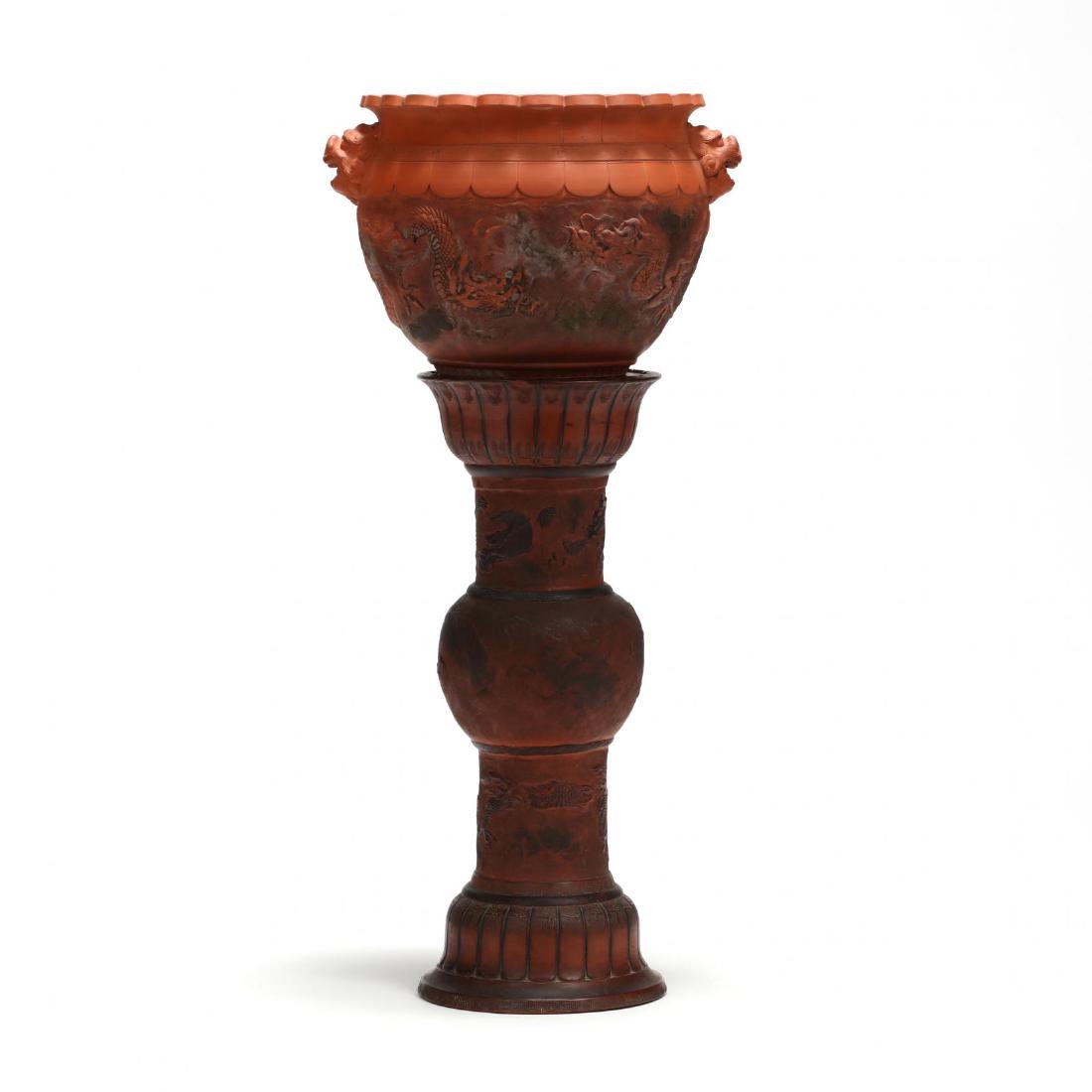 A Japanese Tokoname Redware Dragon Jardiniere and Stand: A Japanese Tokoname Redware Dragon Jardiniere and Stand early 20th century, jardiniere is decorated with raised three toe dragons, the stand is also decorated with a dragon in relief wrapped around th