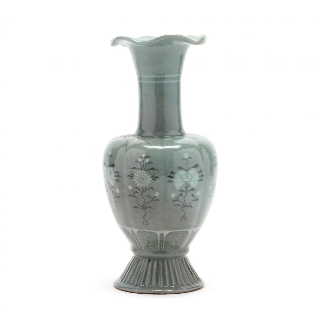 A Contemporary Korean Celadon Vase Signed: A Contemporary Korean Celadon Vase Signed 20th century, an elegant vase with inlay decoration in Goryeo dynasty style of flowers and ruyi, with fluted rim and slightly lobed bulbous body on high foot 