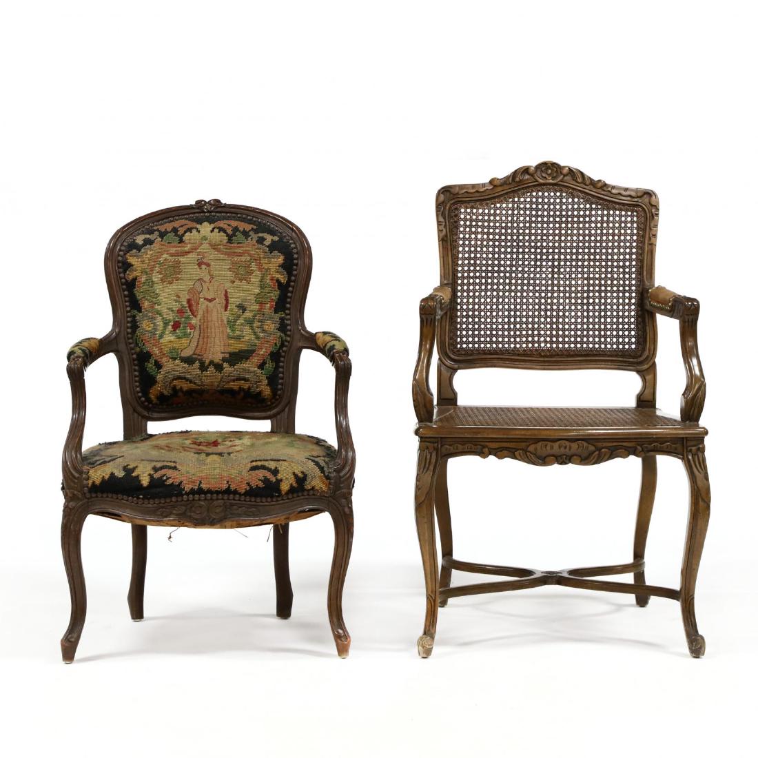 Two Vintage French Fauteuil: Two Vintage French Fauteuilthe larger mid 20th century, distressed walnut frame with caned back and seat, with suede arms, cross stretcher arms; and an early 20th century carved fruitwood chair with n