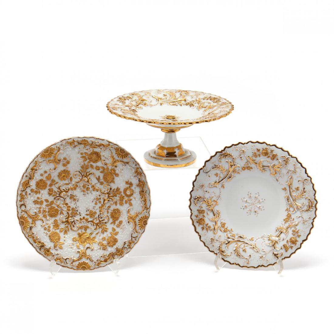 Three Meissen Display, Cabinet Pieces: Three Meissen Display, Cabinet Pieces 19th century attributed to Leuteritz, Rococo style, encrusted with gold in elaborate relief, two plates and a tazza. All with underglaze crossed swords. Plates 8.