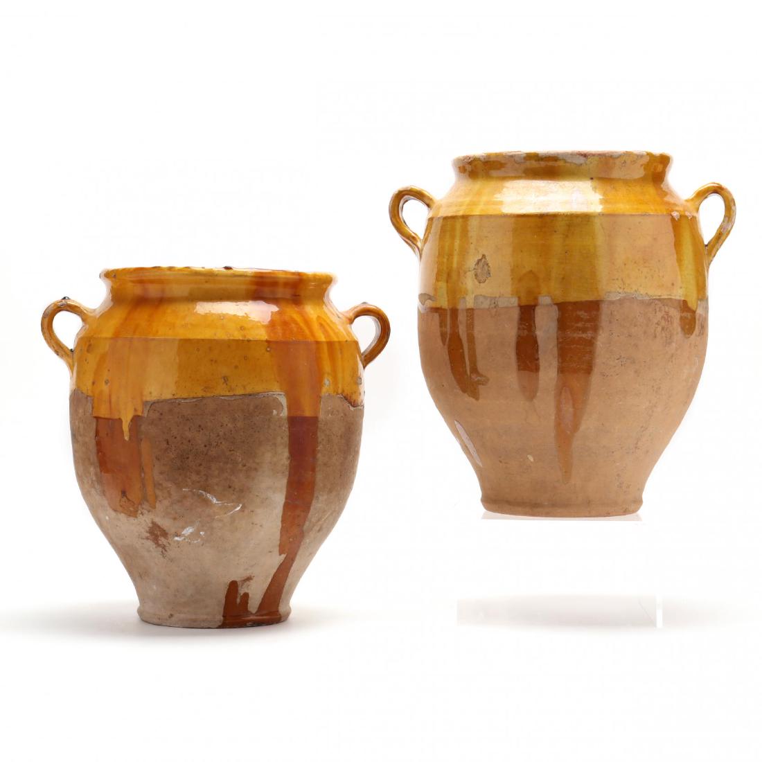 A Large Pair of Antique French Confit Jars: A Large Pair of Antique French Confit Jars terra cotta with yellow glaze, applied ribbed loop handles, high shoulder, tooled base. 14.25 x 15 in. Confit, or food storage jars, were used in provencal F